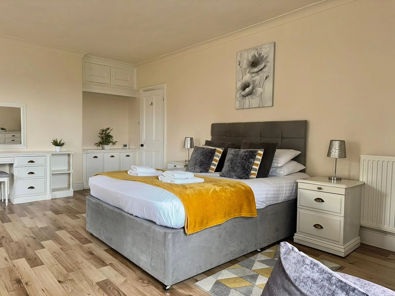 Spacious double bedroom with warm ochre accents