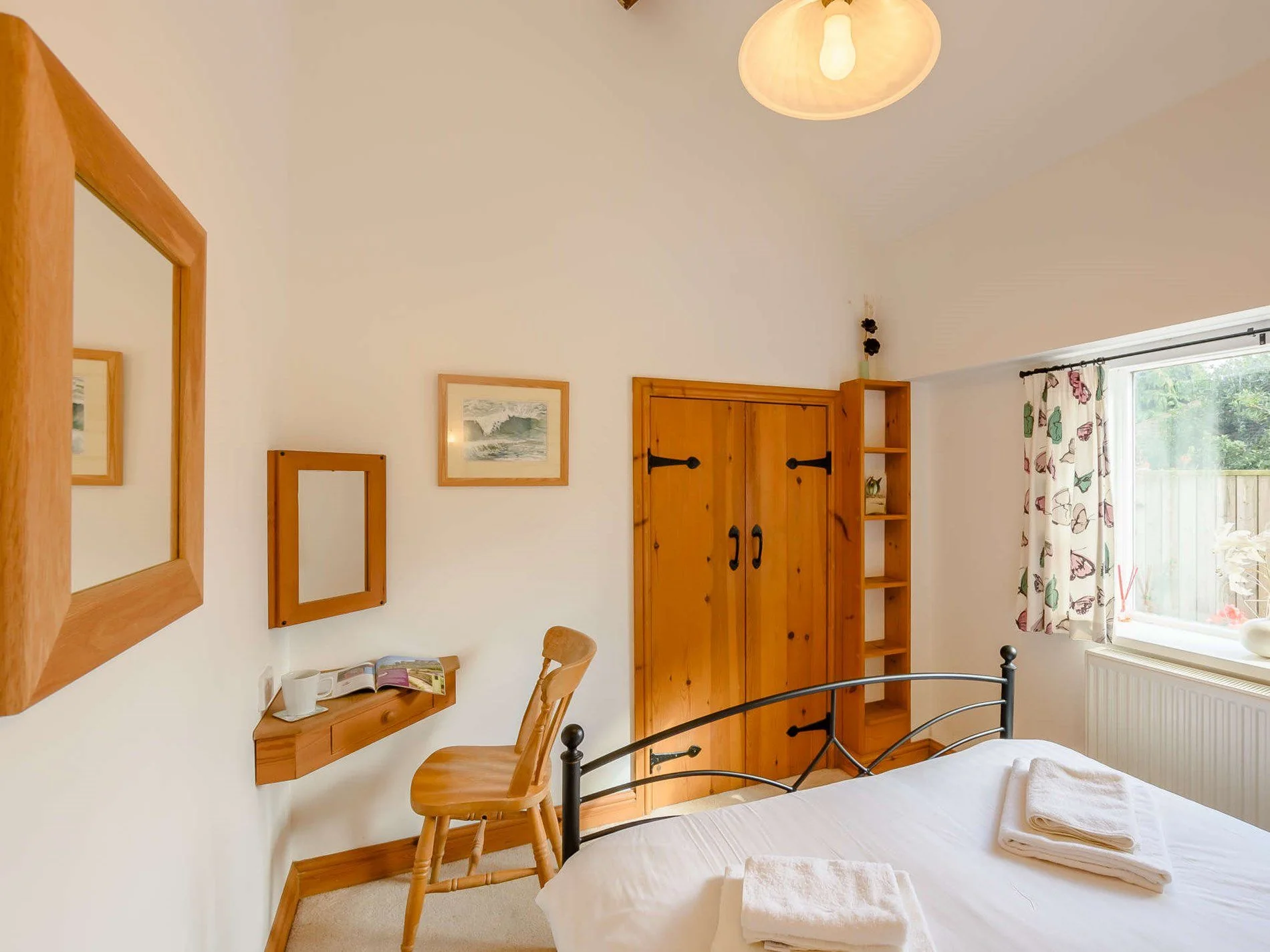Bedroom detail with warm timber storage